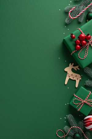 Green vertical holiday scene with wrapped gifts, red berries, candy canes and wooden reindeer creating festive decor for Christmas and New Year celebrationsの写真素材
