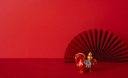 Side view Chinese New Year greeting scene red backdrop decorative figures symbolize luck prosperity celebration warmth joy tradition harmony hopeの写真素材