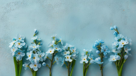Blue flowers arranged in a row against a textured blue background. Fresh, tranquil and colorful, this image evokes spring garden vibes and peaceful beauty. Generated A.I.の素材