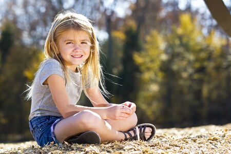 A small female child enjoying a day at the parkの写真素材