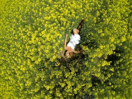 A blonde model in a field of flowersの写真素材