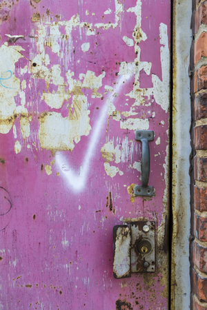 Graphiti on an abandoned door in a city environmentの写真素材