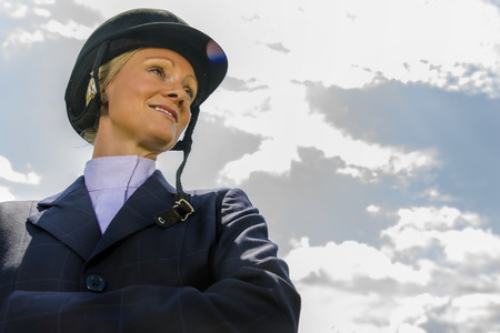 A blonde equestrian model poses in an outdoor environmentの写真素材