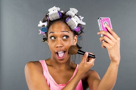 An African American woman putting on makeupの写真素材