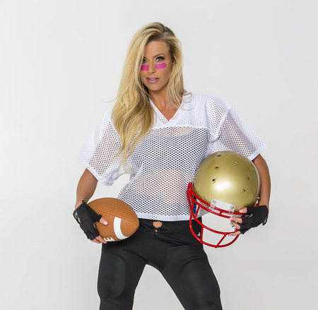 Blonde model posing in football equipmentの写真素材