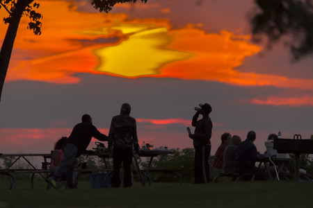 The sun sets on Lake Erie on a summer eveningの写真素材