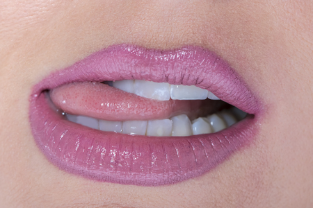 Female lips painted with red lipstick close-up macro