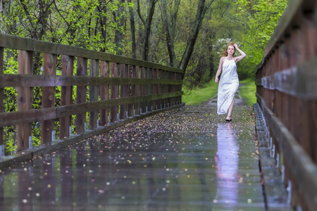 A redhead model posing in an outdoor environment in the rainの写真素材