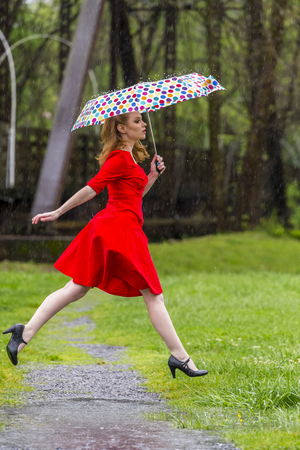A redhead model posing in an outdoor environment in the rainの写真素材