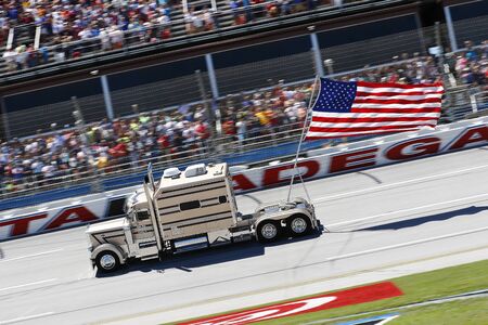 May 07, 2017 - Talladega, Alabama, USA: A truck flies an American flag thru the trial-oval during pre-race ceremonies for the GEICO 500 at Talladega Superspeedway in Talladega, Alabama.のeditorial素材