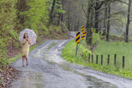 A redhead model posing in an outdoor environment in the rainの写真素材