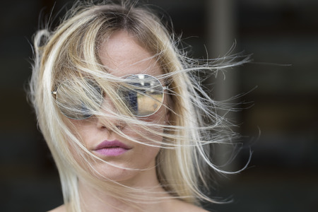 A blonde model posing in an outdoor environmentの写真素材