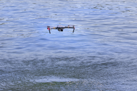 A personal drone flying through the air on a beach.の写真素材