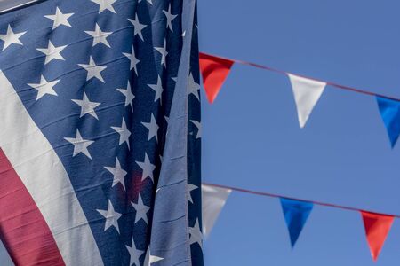 American flag waves in the wind against a blue sky