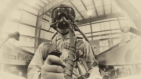 A WWII pilot strapping into a fighter airplaneの写真素材