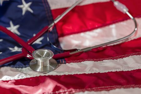 Conception of a stethoscope on an American Flag representing healthcare in the United States.の写真素材