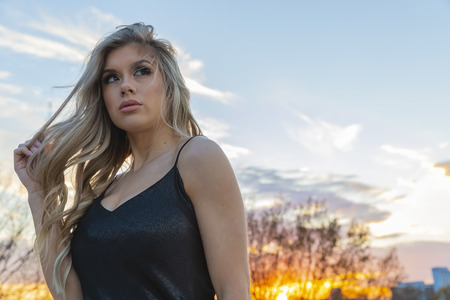 A beautiful blonde model posing outdoors in an urban environmentの写真素材