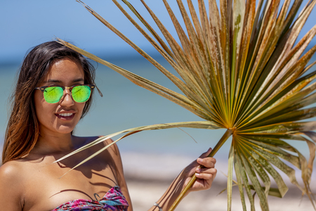 A beautiful hispanic brunette model enjoying a day on the beachのeditorial素材