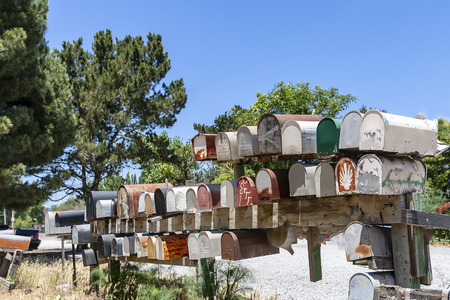 Colorful antique mailboxes sit on a roadsideのeditorial素材