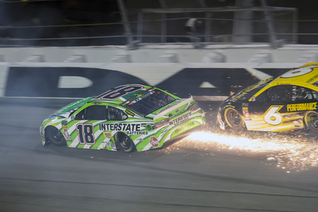 July 07, 2018 - Daytona Beach, Florida, USA: Kyle Busch (18) races through the field off turn four at the Coke Zero Sugar 400 at Daytona International Speedway in Daytona Beach, Florida.のeditorial素材