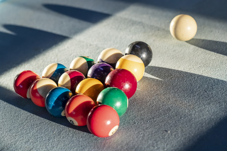 A racked up triangle of billiard balls on the table, ready for a game of poolの写真素材