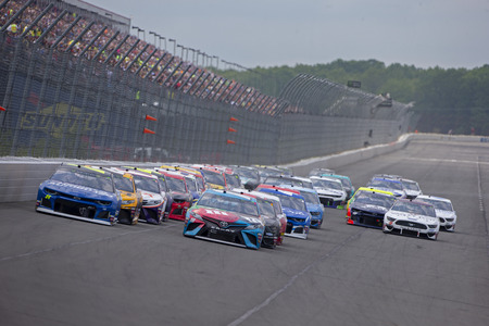 June 02, 2019 - Long Pond, Pennsylvania, USA: Kyle Busch (18) leads the field down the front stretch during the Pocono 400 at Pocono Raceway in Long Pond, Pennsylvania.のeditorial素材