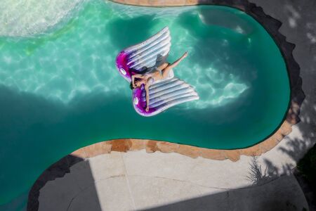 A gorgeous brunette model enjoys a day at the pool