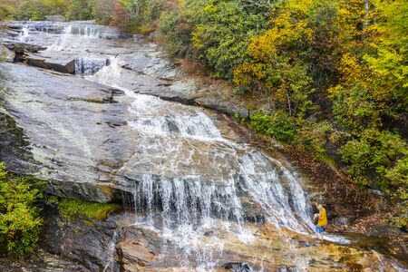A waterfalls sits nestled in the Carolina mountains on an autumn day
