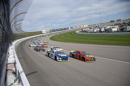 Martin Truex Jr. (19) races for position for the Hollywood Casino 400 at Kansas Speedway in Kansas City, Kansas.のeditorial素材