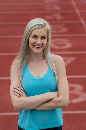 A beautiful young college athlete prepares herself for a track meet at a local university
