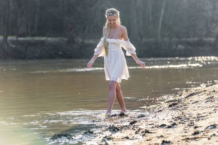 A gorgeous blonde model enjoys a spring day outdoors の写真素材