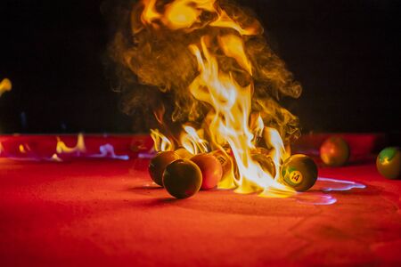 Billiard balls are photographed on fire while sitting outdoors in an open environmentの写真素材
