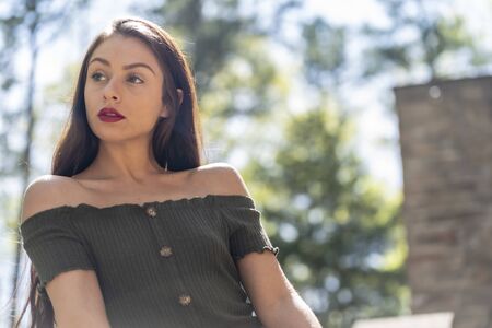 A gorgeous brunette model enjoys a spring day outdoorsの写真素材