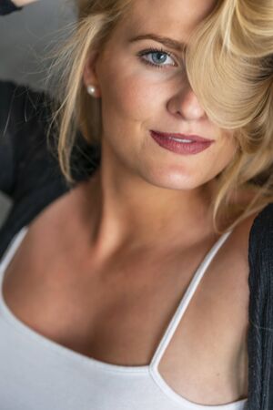 A gorgeous blonde model enjoys a day at home before workの写真素材