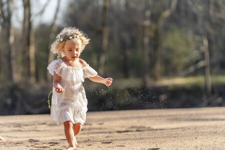 A gorgeous young girl enjoys a spring day outdoorsの写真素材