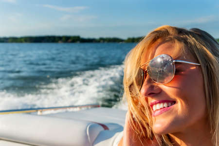 A gorgeous model enjoying a day on the boatの写真素材