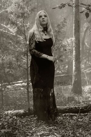 A gorgeous gothic model acts in a forest environmentの写真素材