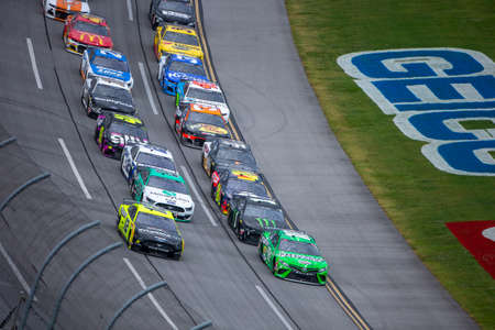 Kyle Busch (18) races for position for the GEICO 500 at Talladega Superspeedway in Lincoln, Alabama.のeditorial素材