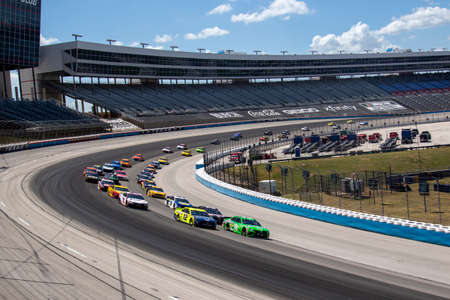Kyle Busch (18) races for position the O'Reilly Auto Parts 500 at Texas Motor Speedway in Fort Worth, Texas.のeditorial素材