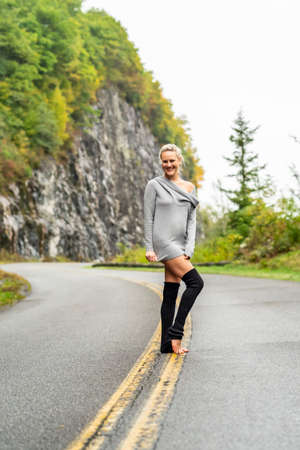 A gorgeous blonde model enjoys the fall weather on a fall dayの写真素材