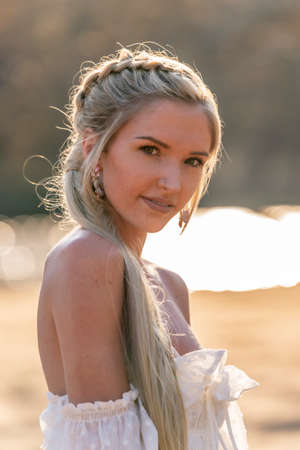 A gorgeous blonde model enjoys a spring day outdoorsの写真素材