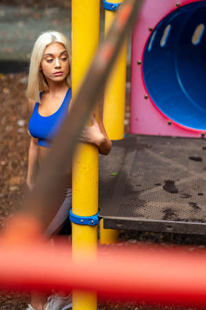 A gorgeous young blonde model works out  outdoors while enjoying a summers day
