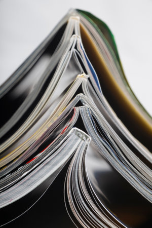 Numerous magazines spread out against a white background in a studio environmentの写真素材