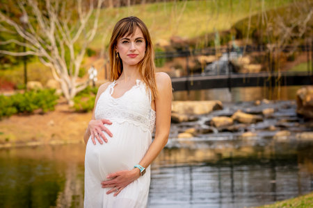 A beautiful expectant mother poses in an outdoor environmentの写真素材