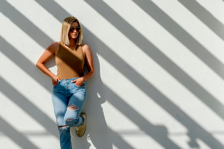 A gorgeous blonde model poses outdoors in her spring clothesの写真素材
