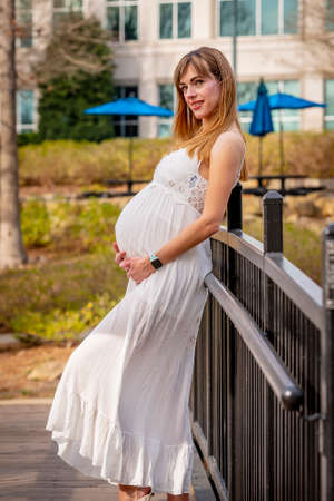A beautiful expectant mother poses in an outdoor environmentの写真素材