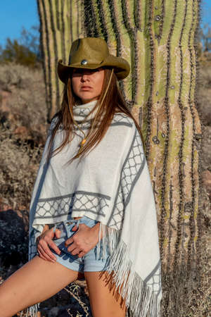 A beautiful hispanic model enjoys the Arizona desert on a sunny dayの写真素材