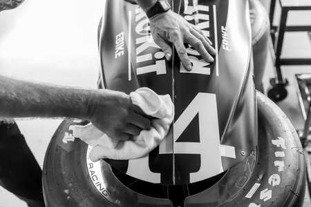 Crewmembers of \14ii\ prepare their car to practice for the GMR Grand Prix at Indianapolis Motor Speedway in Indianapolis, Indiana.のeditorial素材