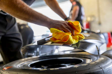 Crewmembers of \14ii\ prepare their car to practice for the GMR Grand Prix at Indianapolis Motor Speedway in Indianapolis, Indiana.のeditorial素材
