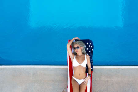 A gorgeous patriotic bikini model enjoys the holiday weekend at a local pool